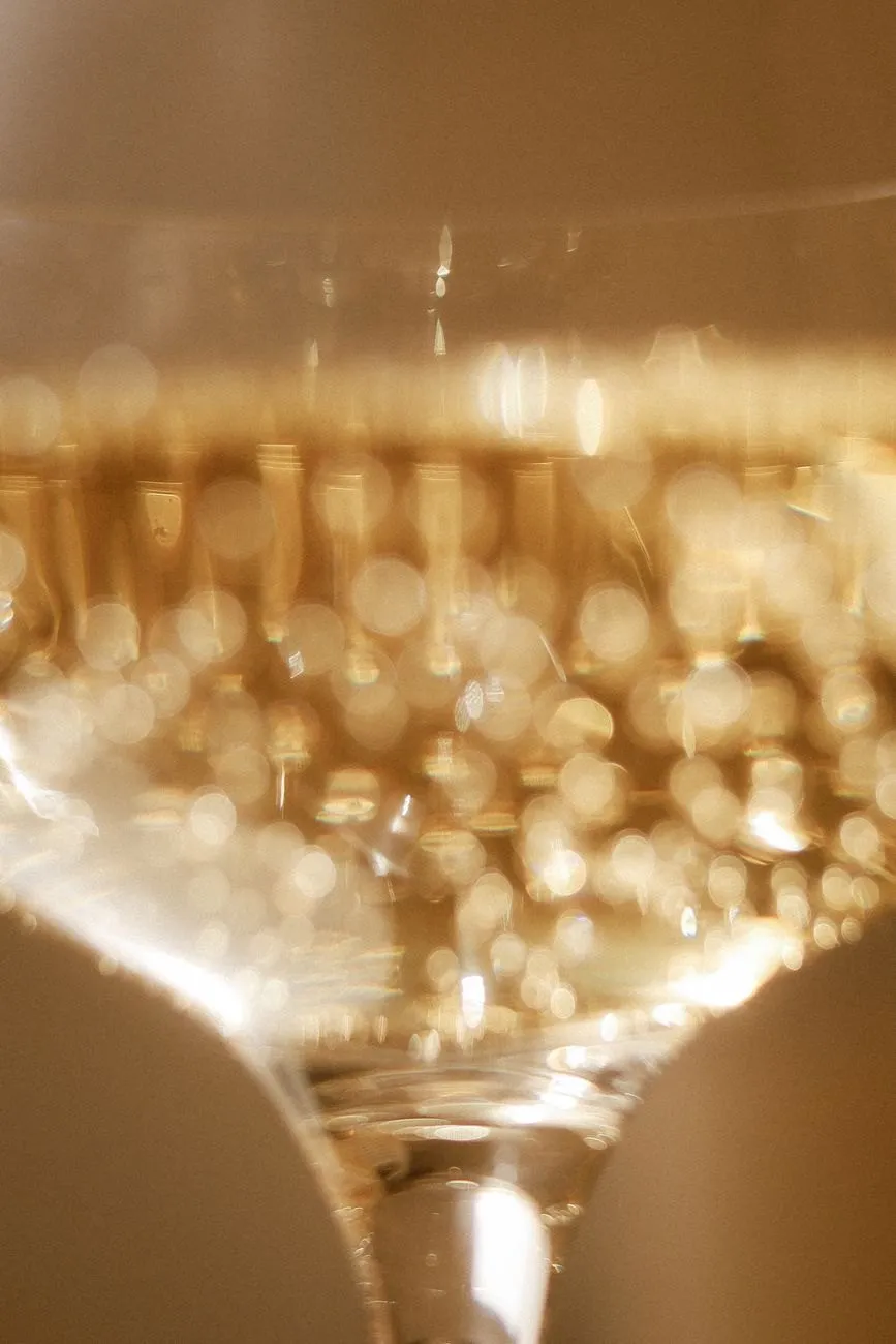 Close view of fine bubbles rising in a glass of golden sparkling wine